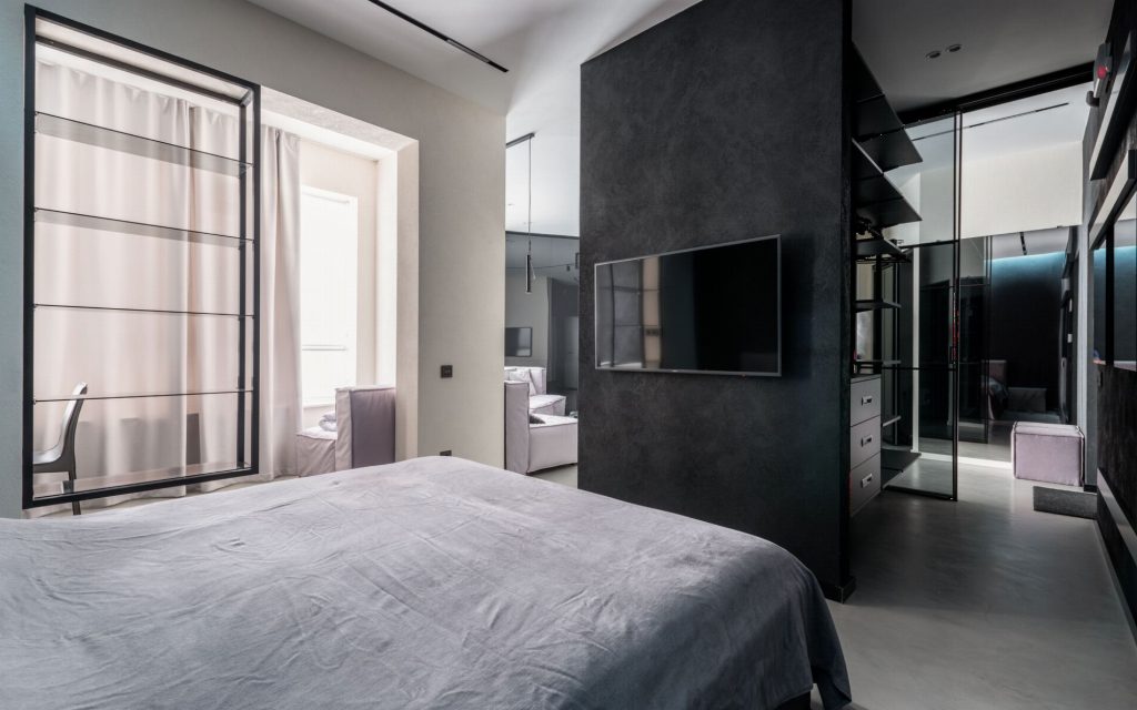A light bedroom framed by curtains